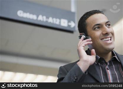 Close-up of a businessman laughing in a hands free device at an airport