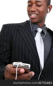 Close-up of a businessman listening to an MP3 player