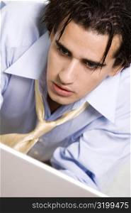 Close-up of a businessman looking at a laptop