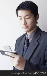 Close-up of a businessman looking at a mobile phone