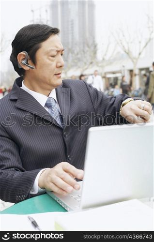 Close-up of a businessman looking at his wrist watch