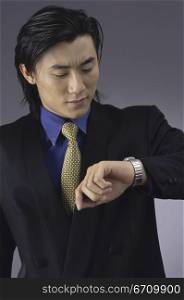 Close-up of a businessman looking at his wristwatch