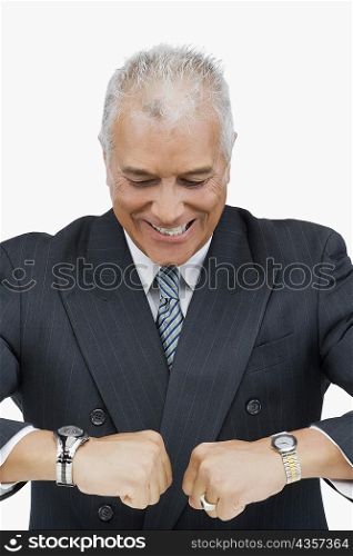 Close-up of a businessman looking at his wristwatches