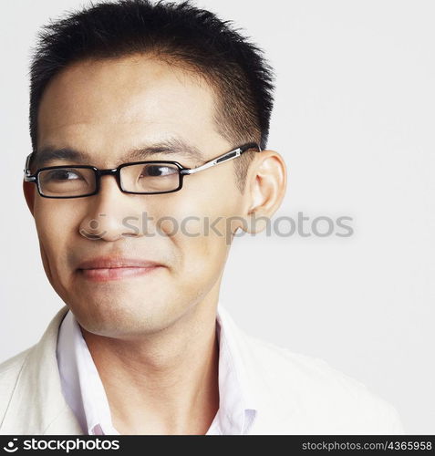 Close-up of a businessman looking away and smirking