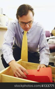 Close-up of a businessman looking into a file in a drawer