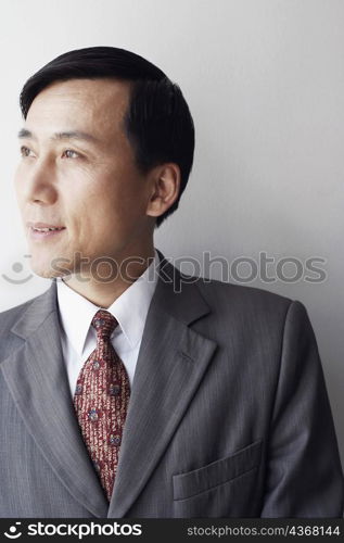 Close-up of a businessman looking sideways smiling