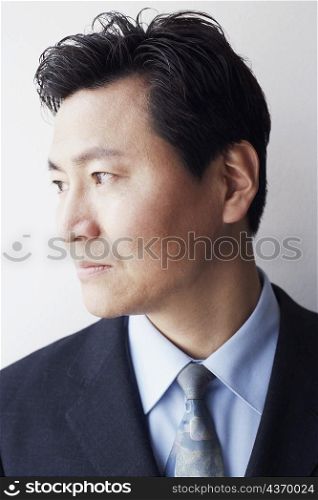 Close-up of a businessman looking sideways smiling