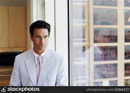 Close-up of a businessman looking through a window