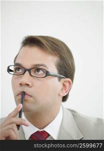 Close-up of a businessman looking up and thinking