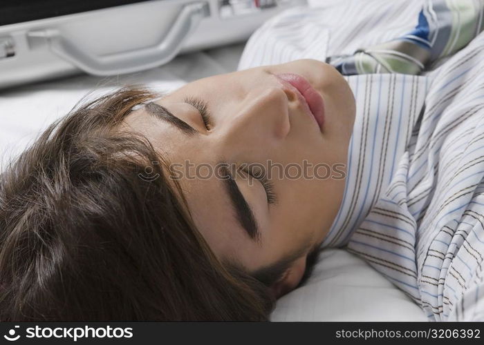 Close-up of a businessman lying on the bed