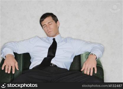 Close-up of a businessman napping in an armchair