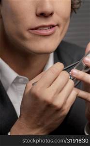 Close-up of a businessman operating a hand held device with a digitized pen