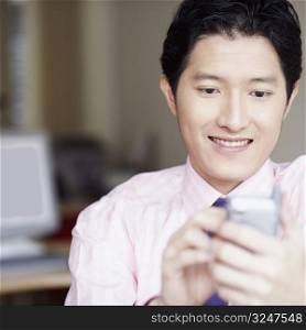 Close-up of a businessman operating a personal data assistant with a digitized pen