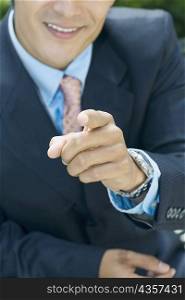 Close-up of a businessman pointing forward
