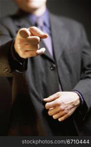 Close-up of a businessman pointing forward