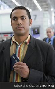 Close-up of a businessman putting a passport in his coat&acute;s pocket