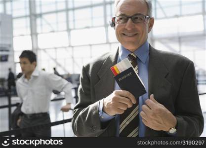 Close-up of a businessman putting a passport with an airplane ticket in his coat&acute;s pocket