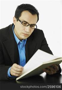 Close-up of a businessman reading a book