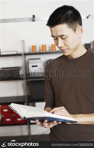 Close-up of a businessman reading a book