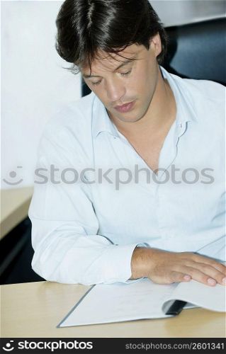 Close-up of a businessman reading a file