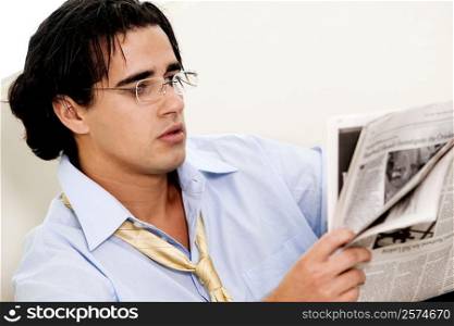 Close-up of a businessman reading a newspaper