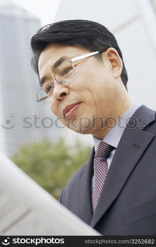 Close-up of a businessman reading a newspaper