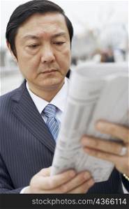 Close-up of a businessman reading a newspaper