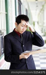 Close-up of a businessman reading mails and looking upset