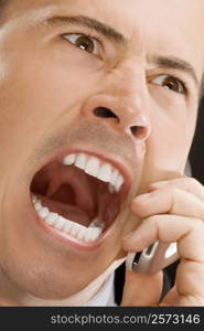 Close-up of a businessman shouting on a mobile phone