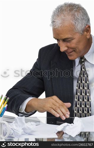 Close-up of a businessman sitting at a desk in an office