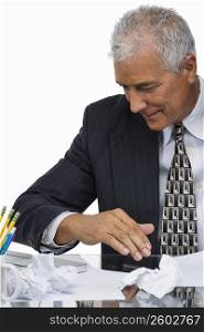 Close-up of a businessman sitting at a desk in an office