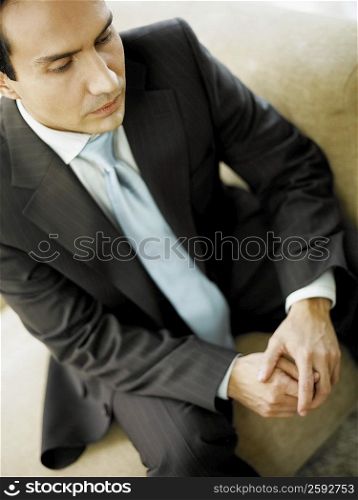 Close-up of a businessman sitting on a couch