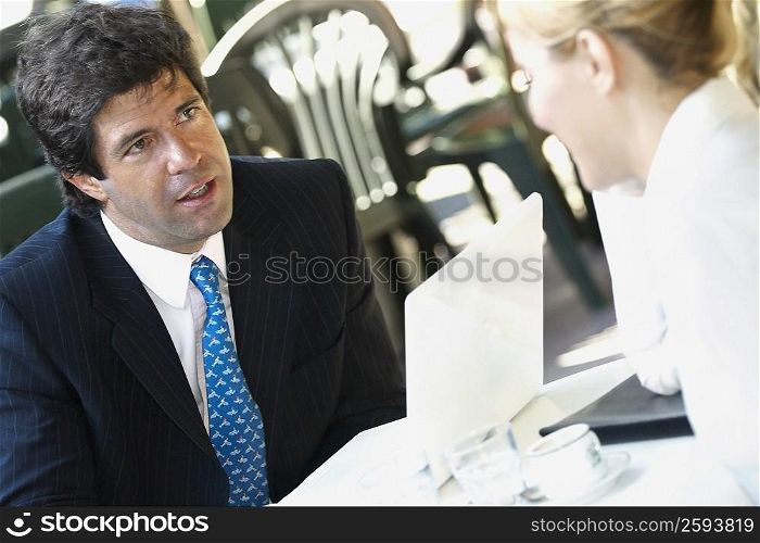 Close-up of a businessman sitting with a businesswoman