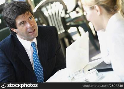 Close-up of a businessman sitting with a businesswoman