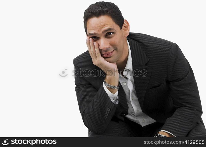 Close-up of a businessman sitting with his hand on his chin