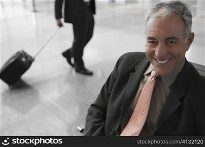 Close-up of a businessman smiling at an airport