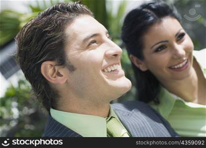 Close-up of a businessman smiling with a businesswoman