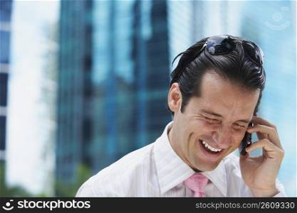 Close-up of a businessman talking on a mobile phone and smiling