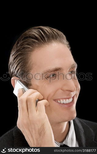 Close-up of a businessman talking on a mobile phone and smiling