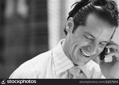 Close-up of a businessman talking on a mobile phone and smiling
