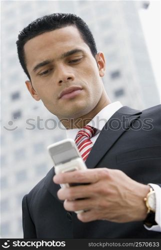 Close-up of a businessman text messaging