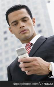 Close-up of a businessman text messaging