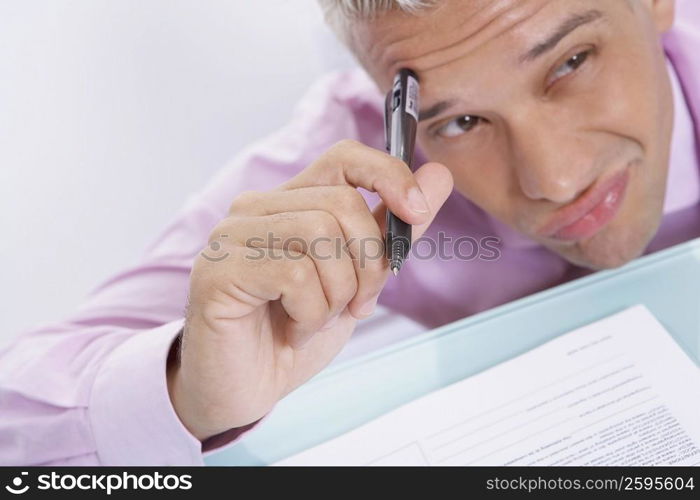 Close-up of a businessman thinking and making a face
