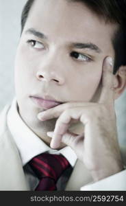 Close-up of a businessman thinking with his hand on his chin