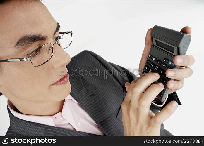 Close-up of a businessman using a calculator