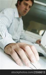 Close-up of a businessman using a computer mouse
