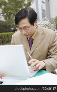 Close-up of a businessman using a laptop