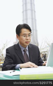 Close-up of a businessman using a laptop