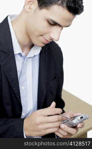 Close-up of a businessman using a personal data assistant