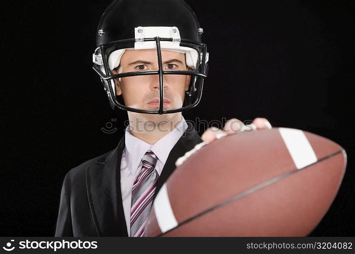 Close-up of a businessman wearing a football helmet